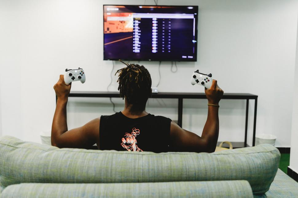 Free Image of Gamer playing video game on TV 