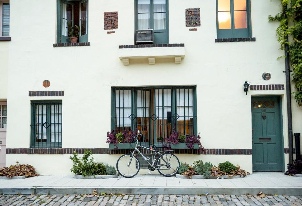 Free Image of Bicycle parked in front of quaint house 
