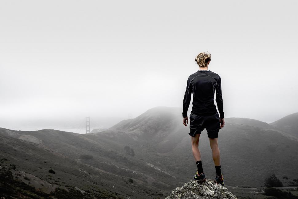 Free Image of Runner overlooking bridge and hills 