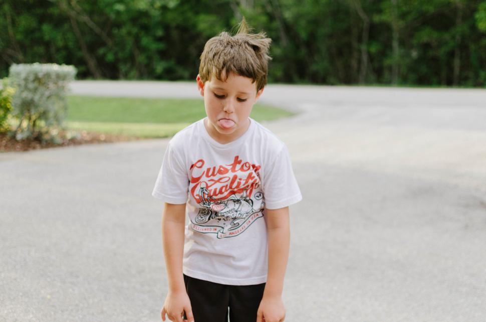Free Image of Young boy making a funny face outdoors 