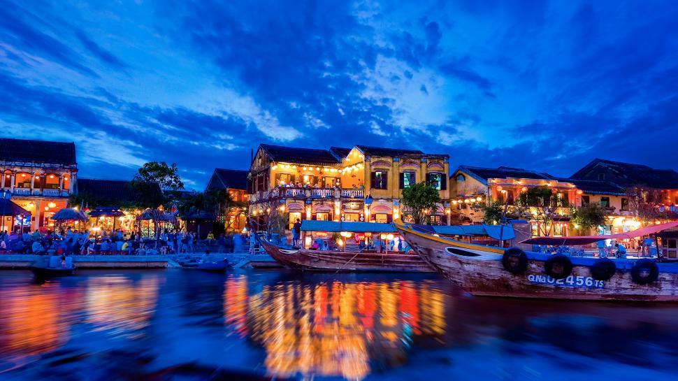 Free Image of Lively riverside town at twilight 