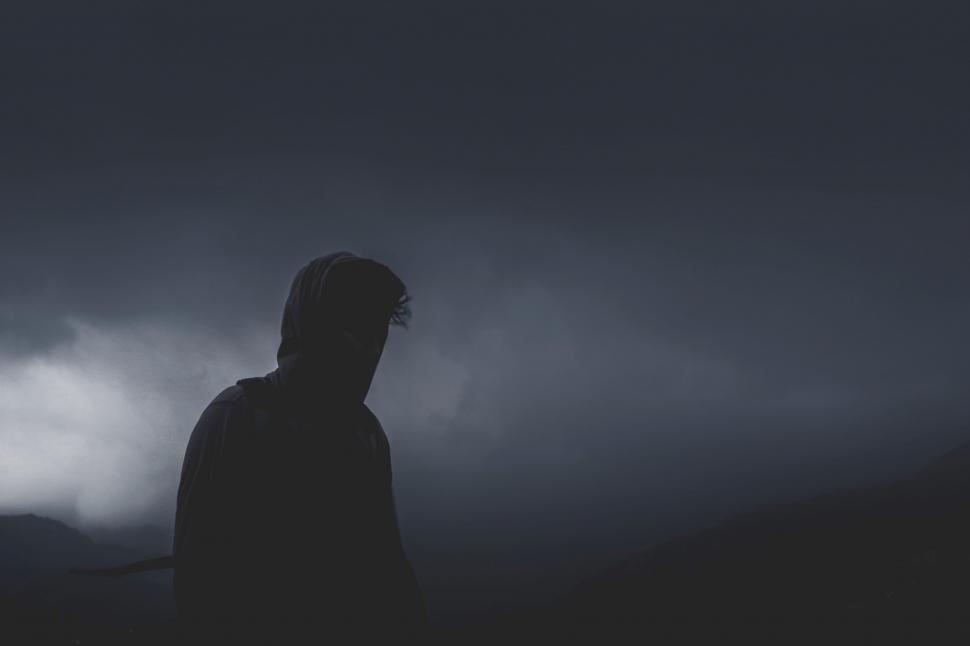 Free Image of Silhouette of a person in a moody landscape 
