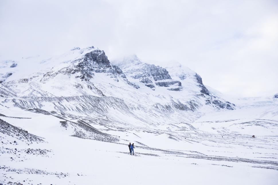 Free Image of Snowy mountain landscape with hiker 