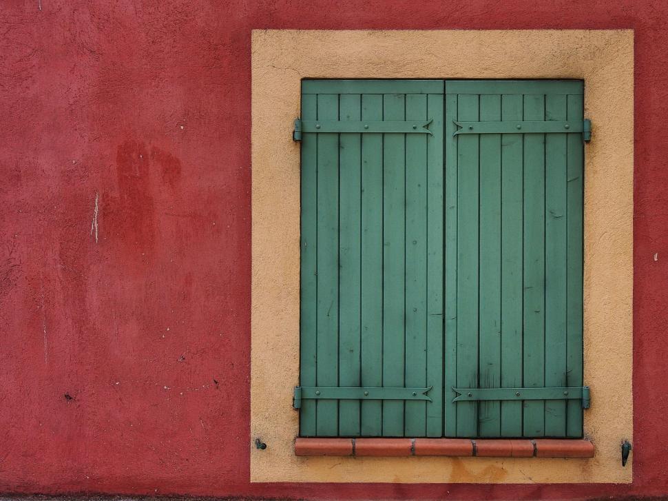Free Image of Green shutters on a vibrant red wall 