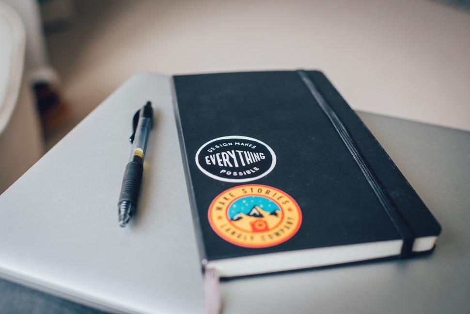 Free Image of Notebook and pen on a desk 