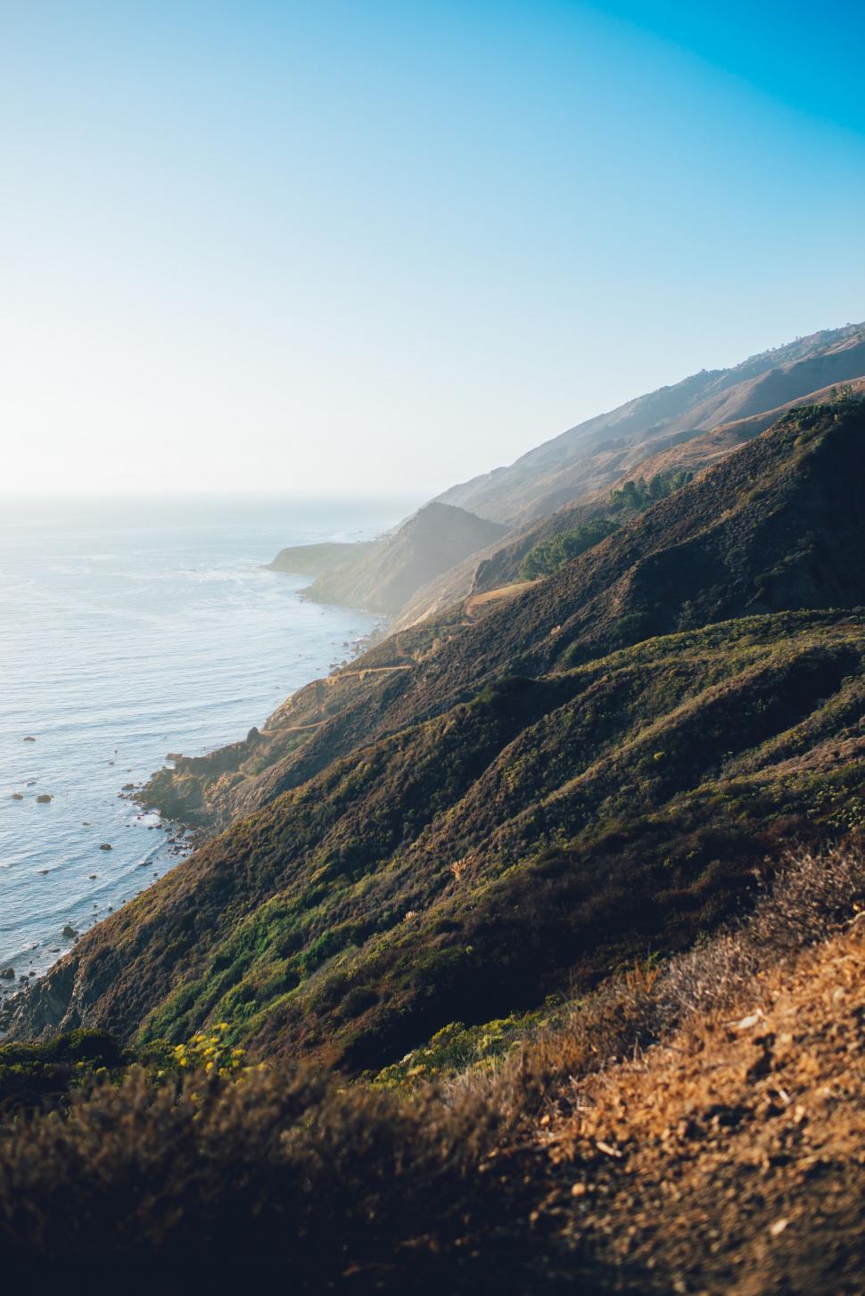 Free Image of Golden hour over coastal hills 