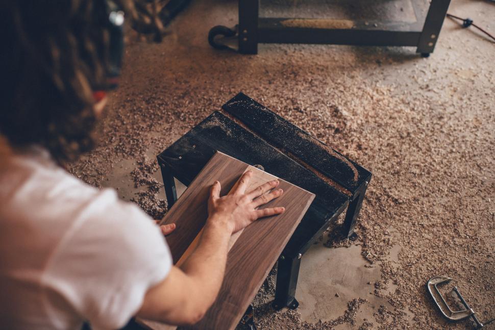 Free Image of Carpenter sanding wooden furniture 
