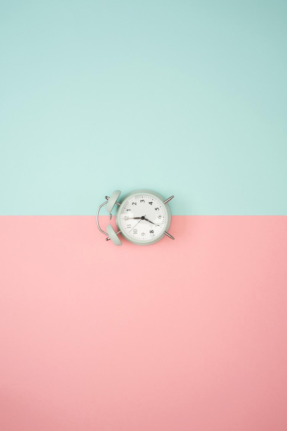 Free Image of Alarm clock on a two-toned background 