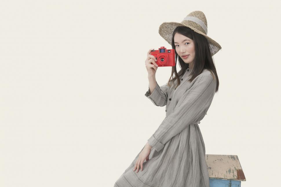Free Image of Woman posing with retro camera 