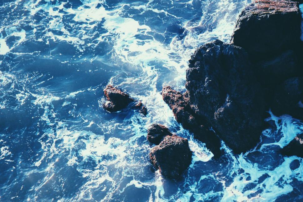 Free Image of Ocean waves washing over coastal rocks 