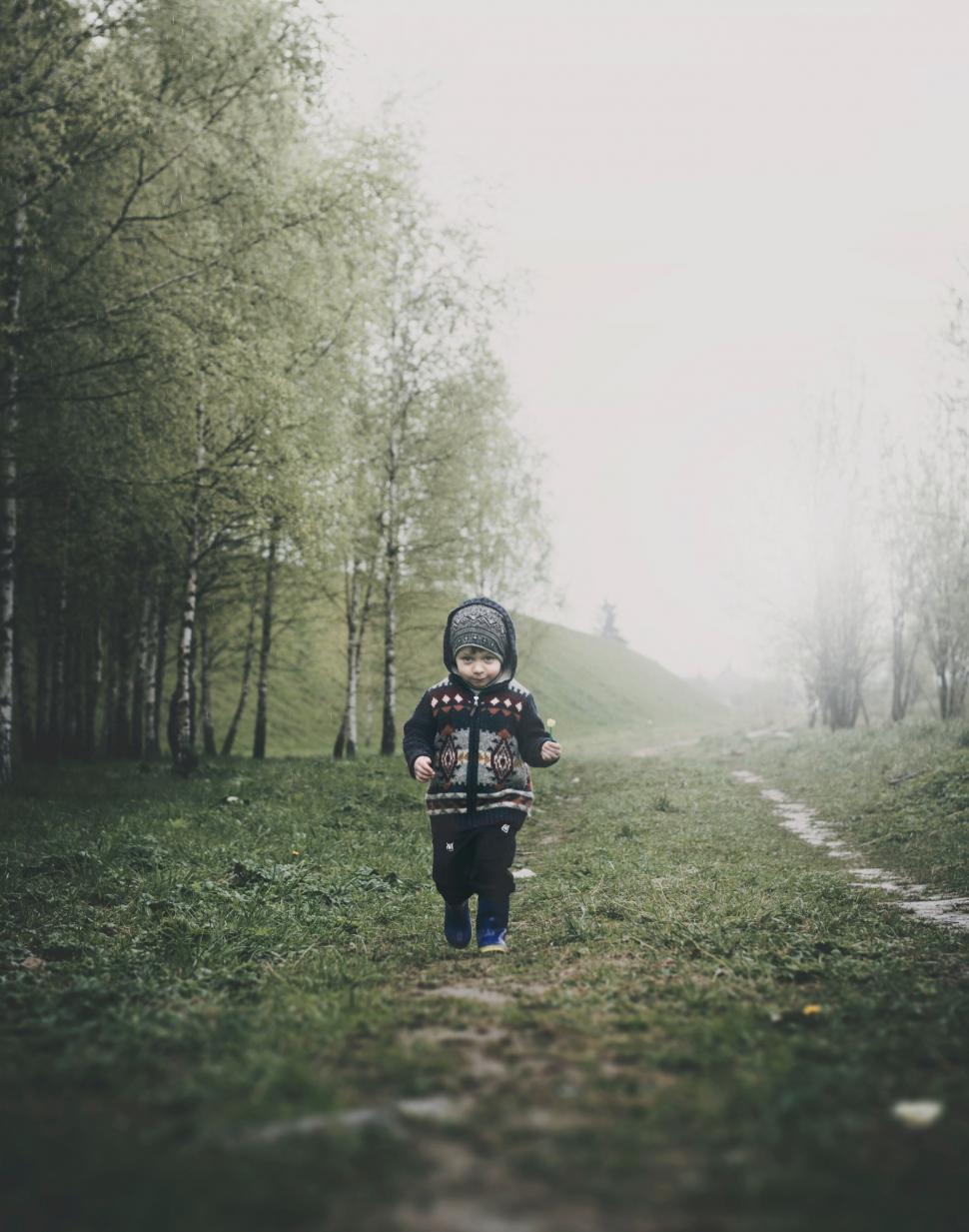 Free Image of Child walking on a foggy trail 