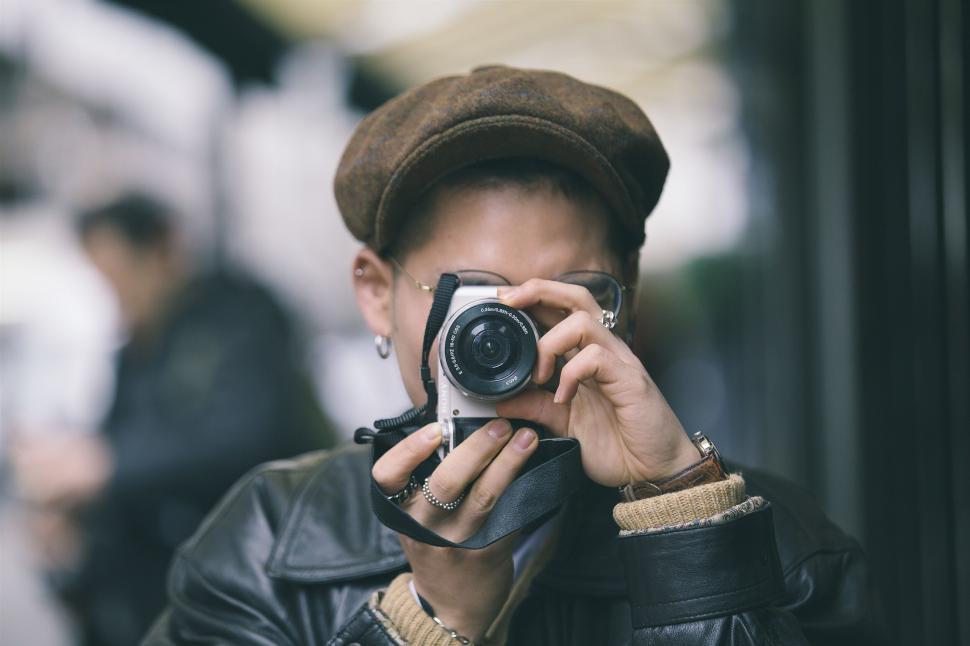 Free Image of Stylish man covering face with hand 