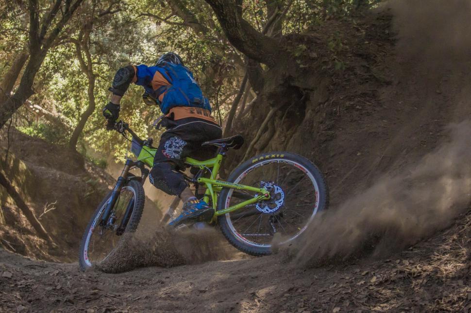 Free Image of Mountain biker on a dusty trail 
