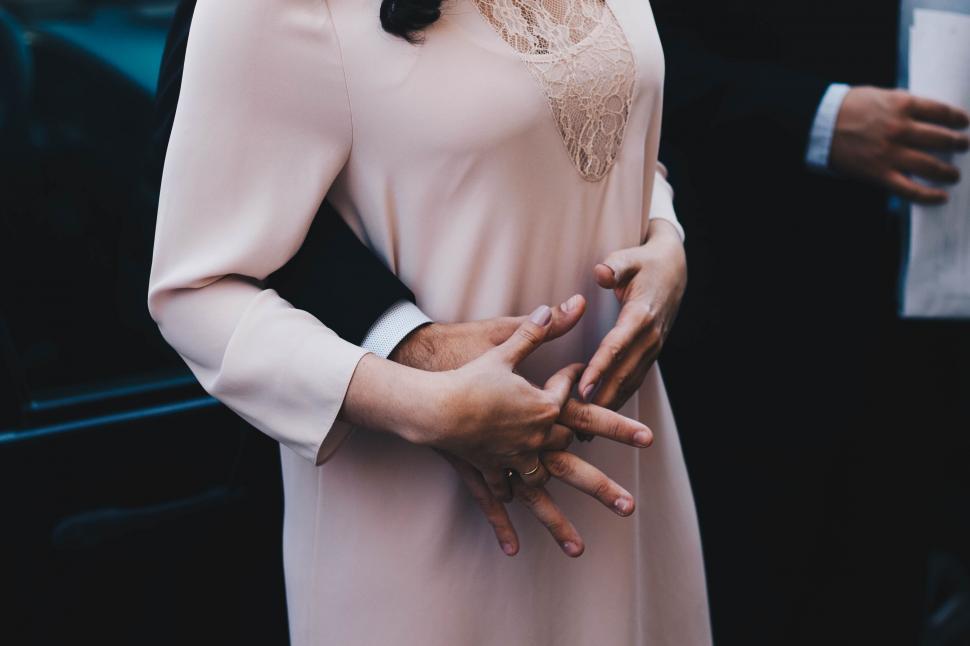 Free Image of Two people exchanging wedding rings 