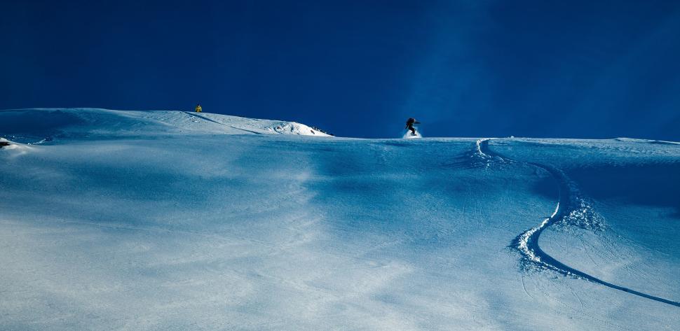 Free Image of Two skiers on a pristine snow slope 