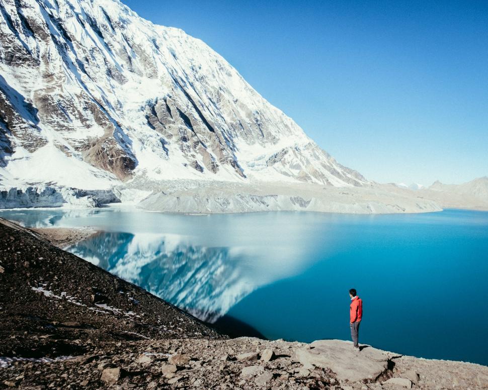 Free Image of Person overlooking tranquil mountain lake 