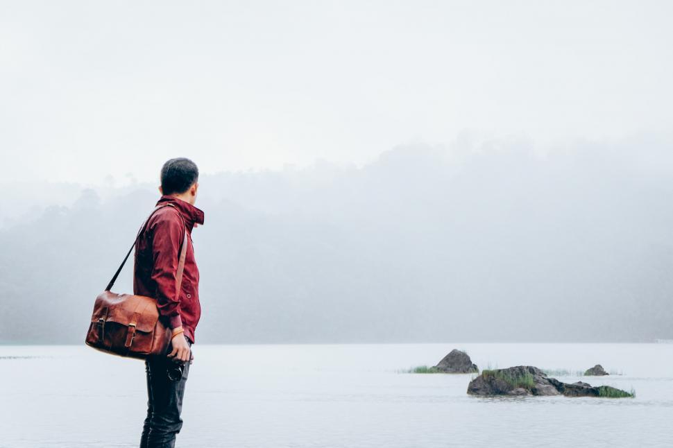 Free Image of Solitary traveler by a foggy lake 