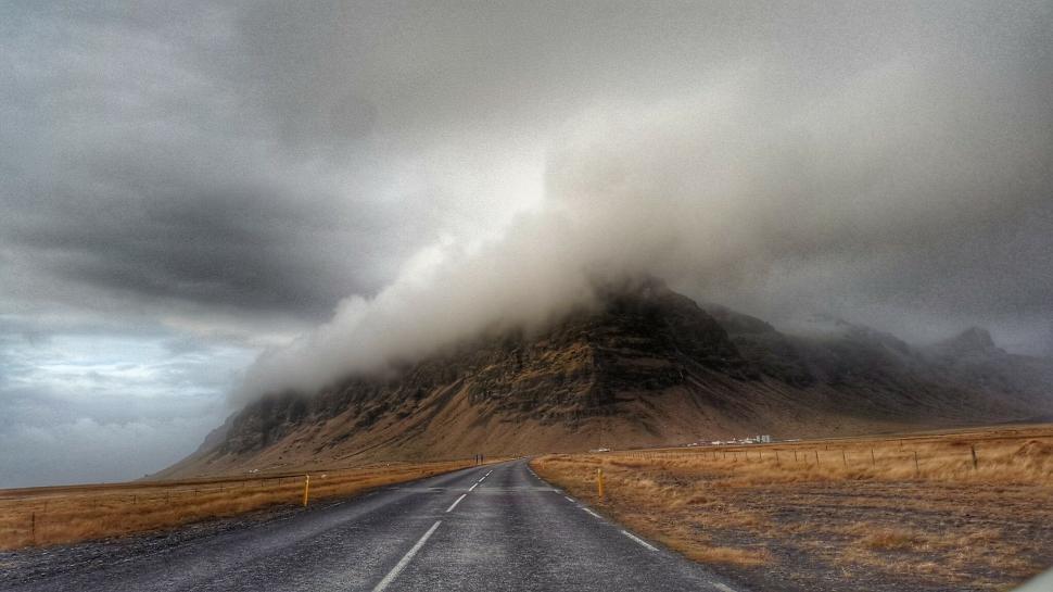 Free Image of Mystical road disappearing into foggy mountains 