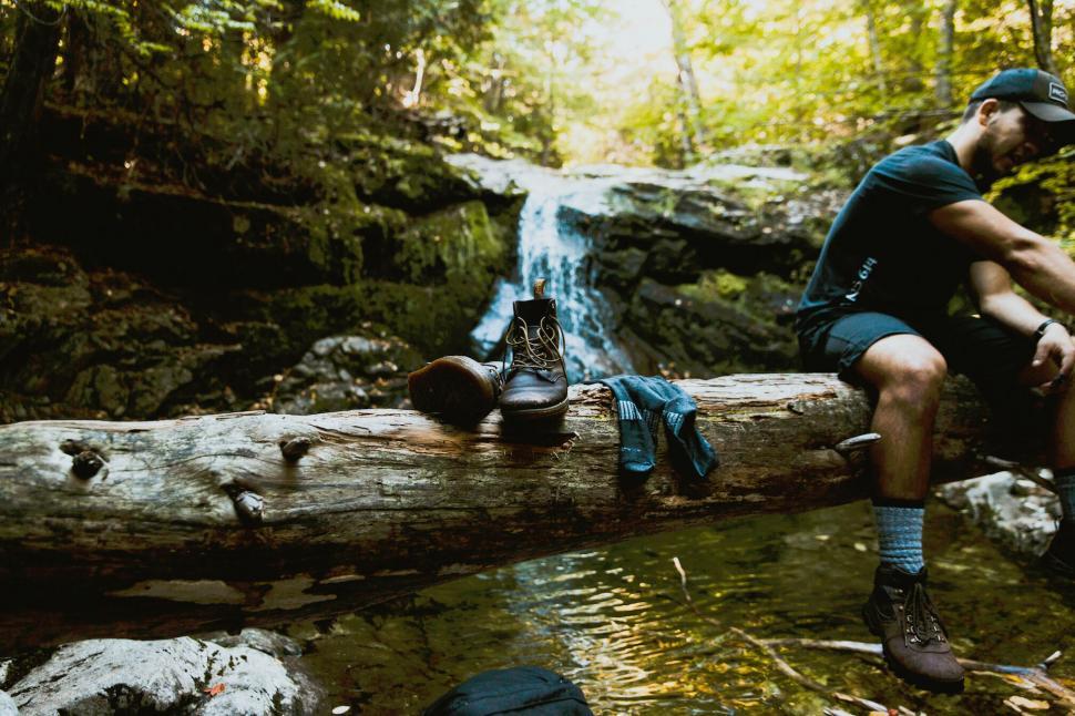 Free Image of Hiking boots and equipment near waterfall 