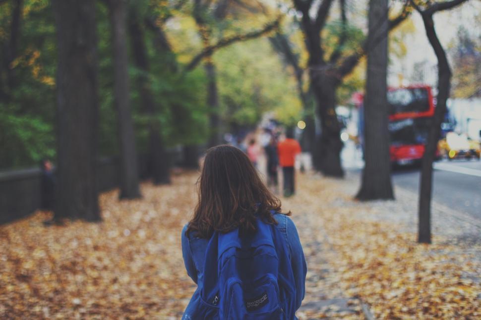 Free Image of Woman walking in autumnal city street 