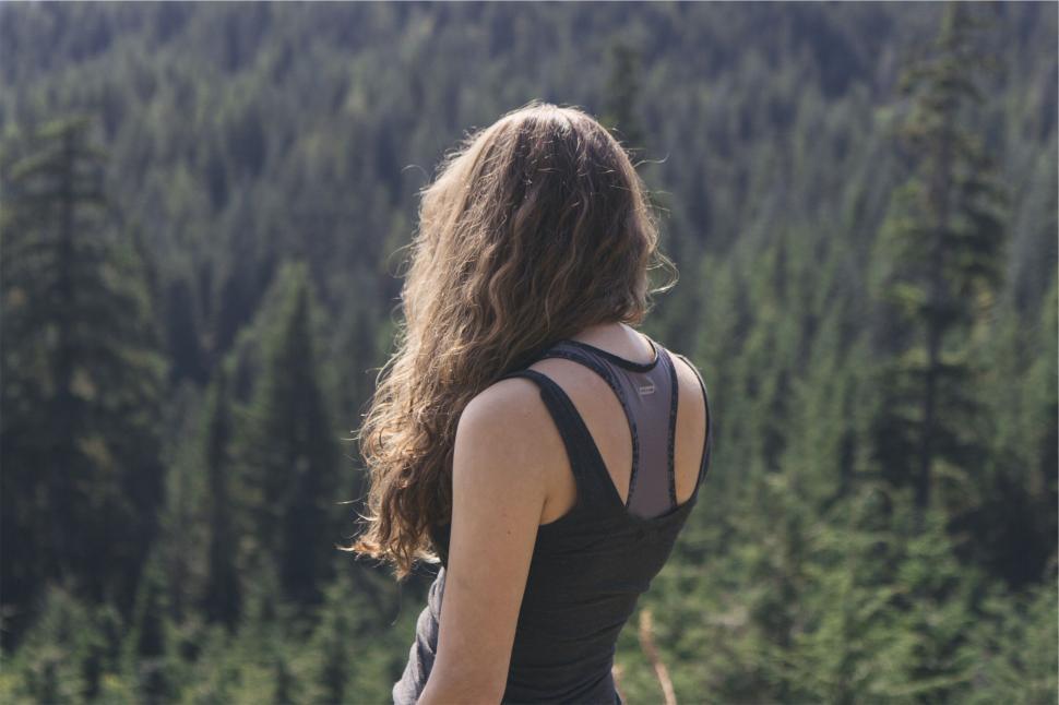 Free Image of Woman facing a lush forest 