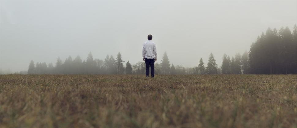 Free Image of Man walking in misty field 