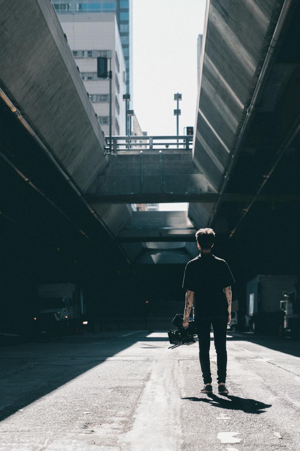 Free Image of Man walking in city underpass 