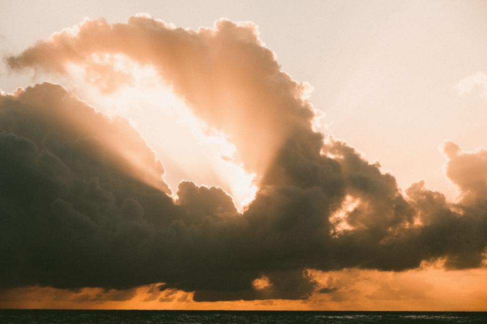 Free Image of Golden clouds during a vibrant sunset 