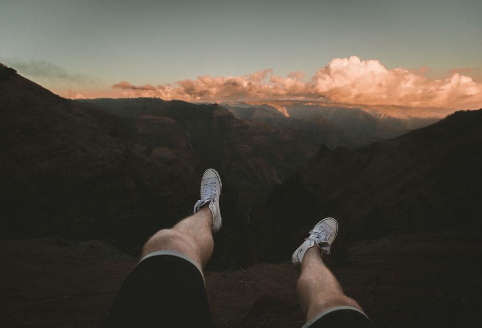 Free Image of Person sitting with feet dangling over edge 