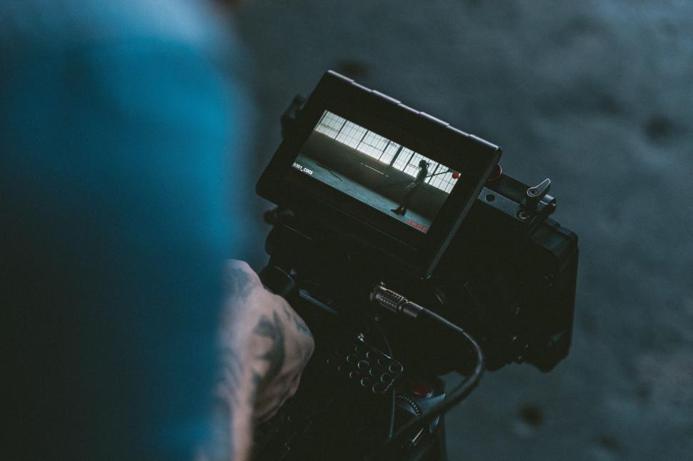 Free Image of Camera operator focusing on screen 