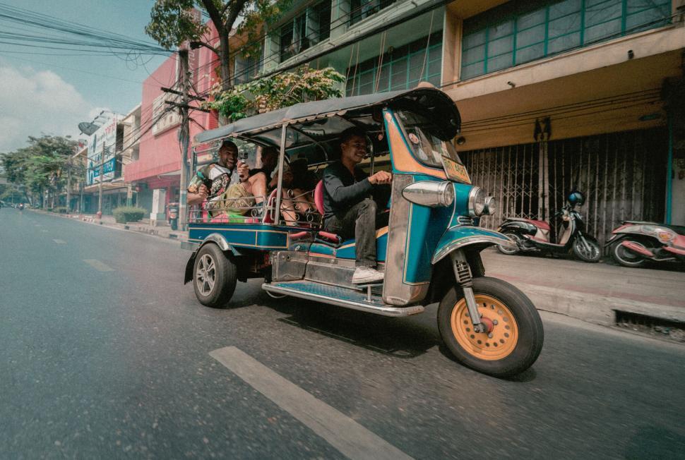 Free Image of Passengers in Tuk Tuk on Urban Street 
