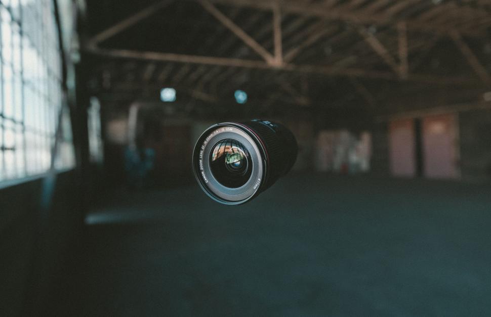 Free Image of Camera lens floating in airy space 