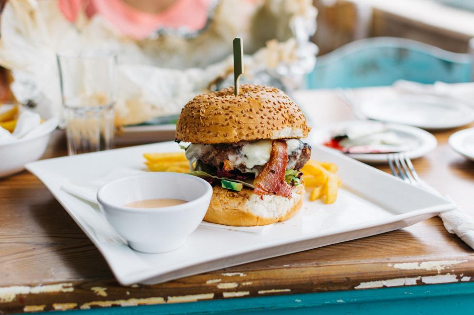 Free Image of Delicious gourmet burger meal on table 