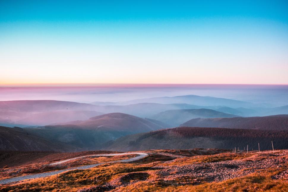 Free Image of Sunrise over mountainous landscape 