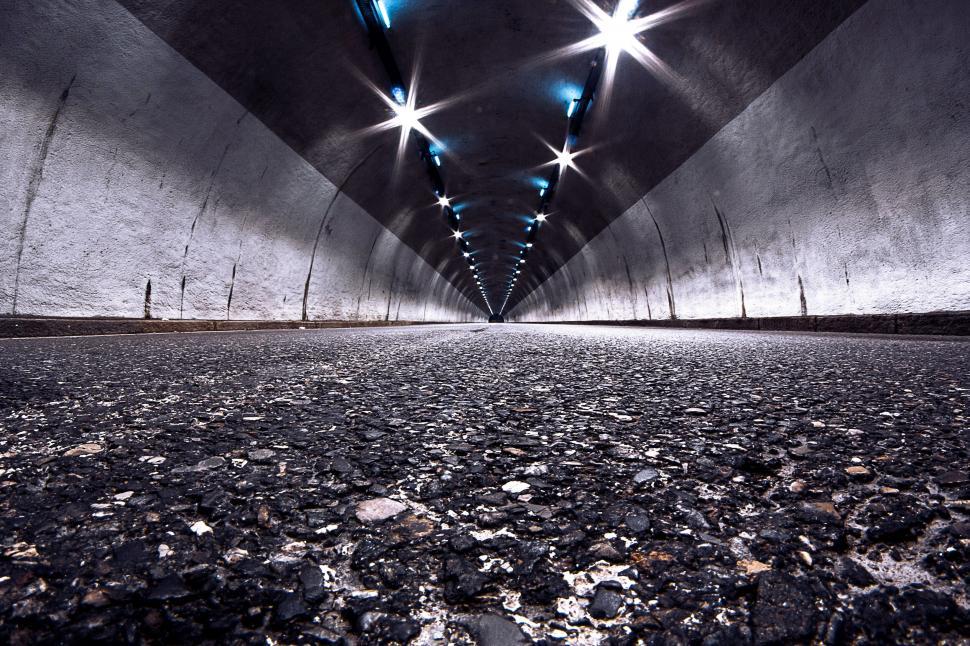 Free Image of Wide-angle view of a tunnel with lights 
