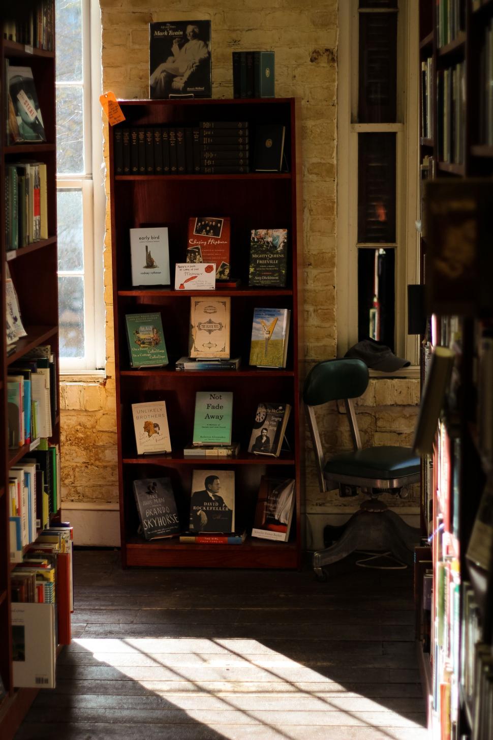 Free Image of Bookshelf with books in cozy reading nook 