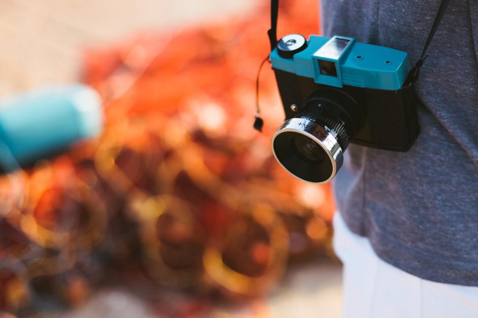 Free Image of Camera hanging on person outdoors 