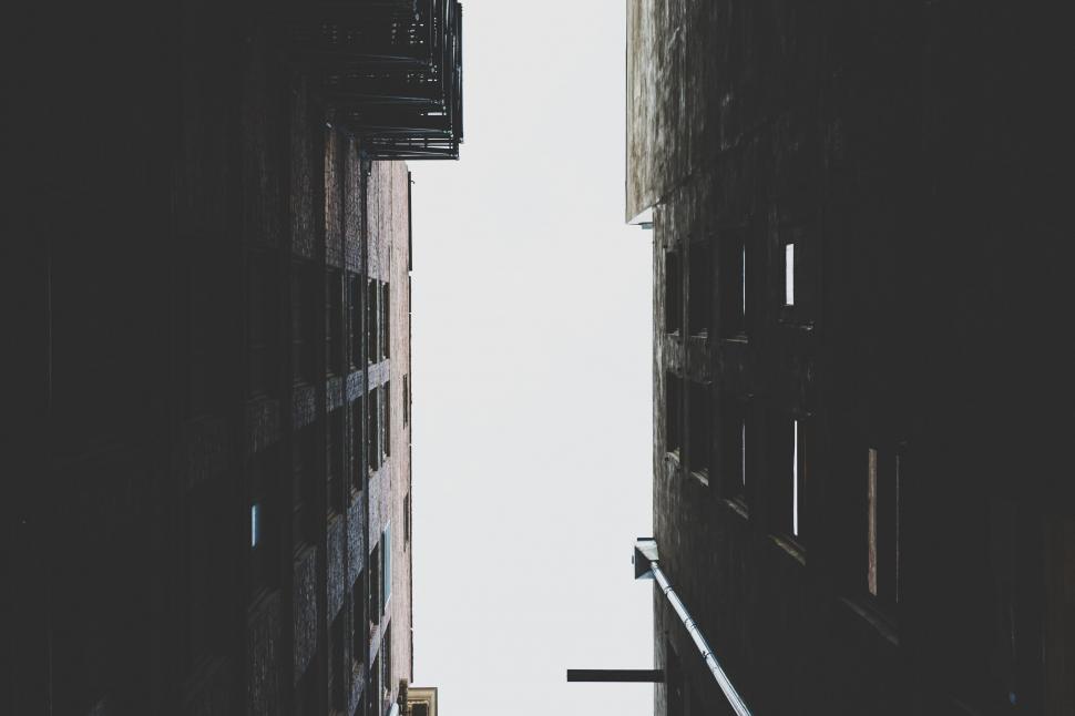 Free Image of Looking up between high-rise buildings 