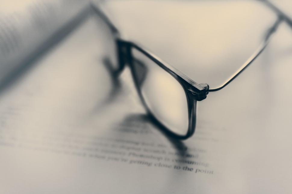 Free Image of Reading glasses on an open book 