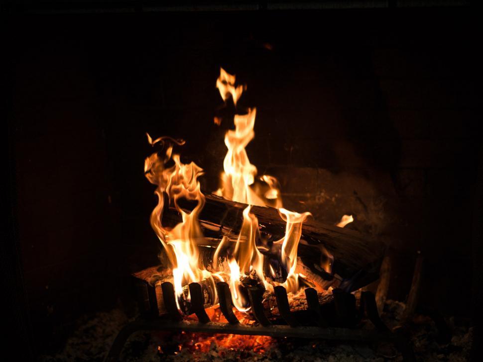 Free Image of Blazing fireplace in dark room 