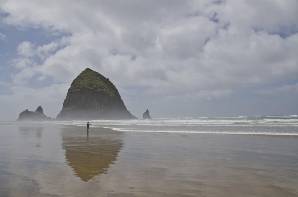 Free Image of Solitary figure on a foggy beach 