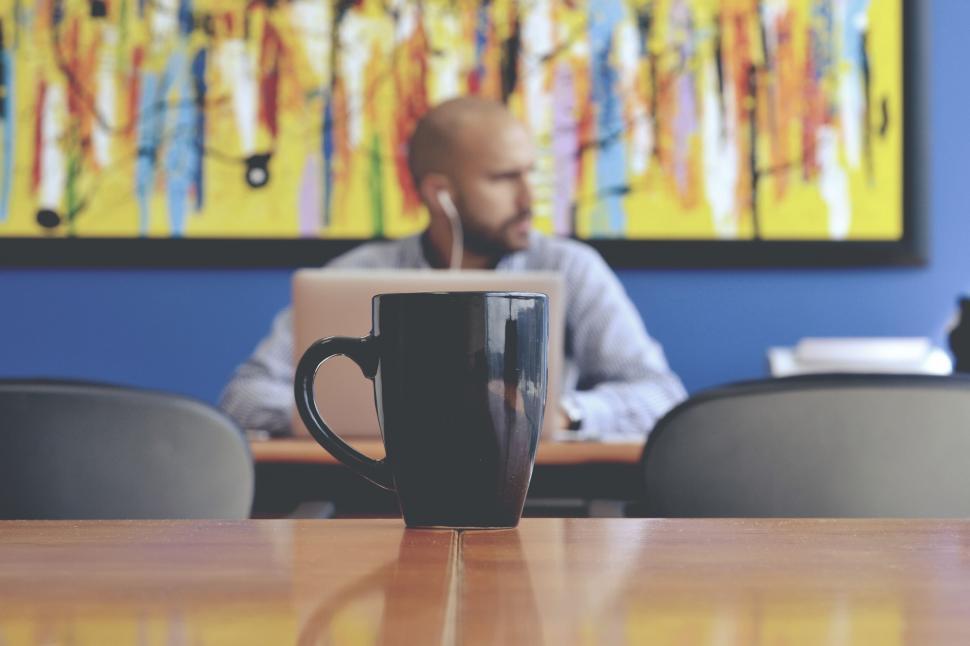 Free Image of Person sitting in a cafe with blurred face 