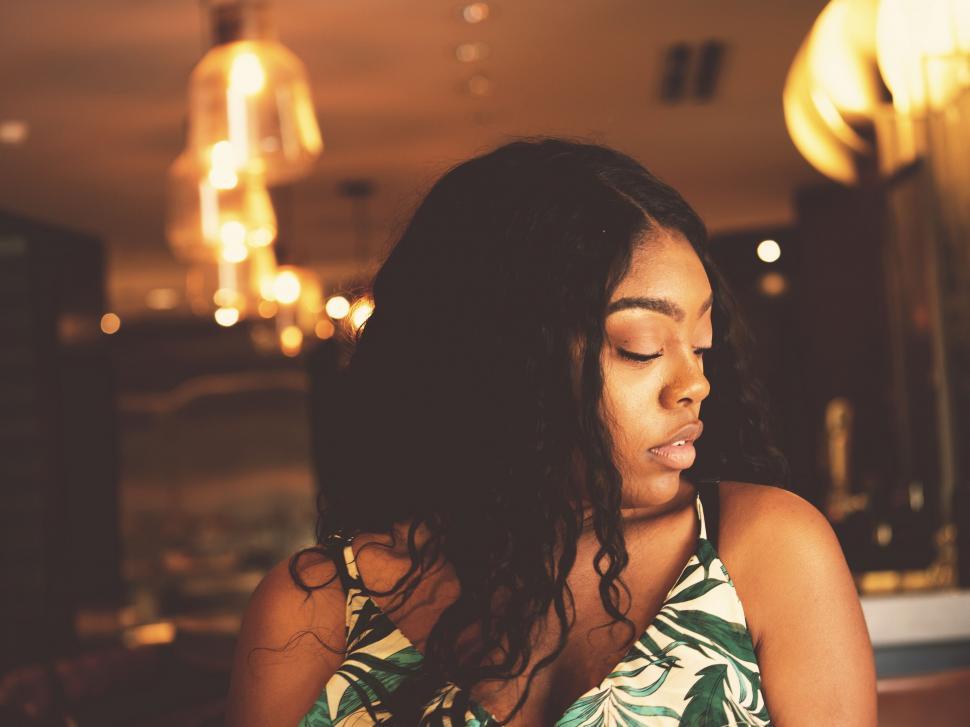 Free Image of Woman in tropical dress under warm light 