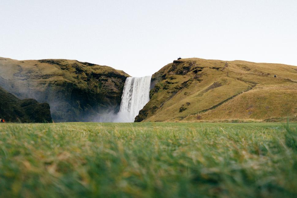 Free Image of Serene waterfall in lush green landscape 