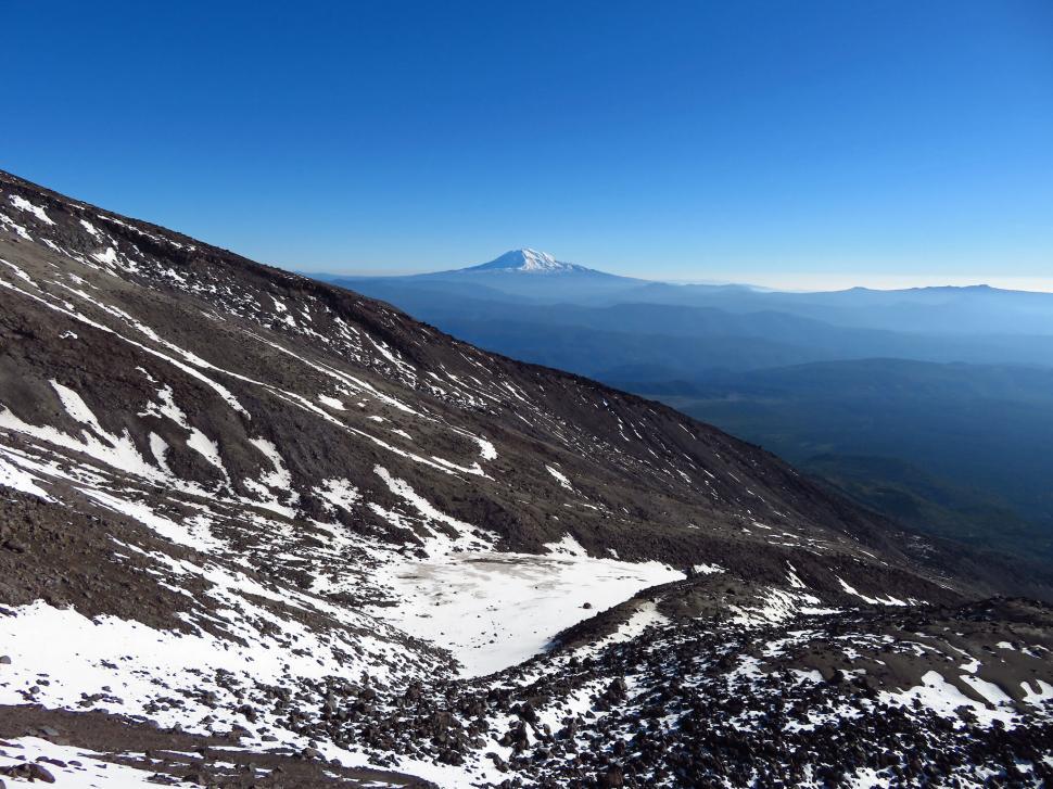 Free Image of Snowy mountain vista with a distant peak 