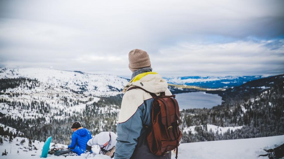 Free Image of Explorer with backpack viewing snowy landscape 