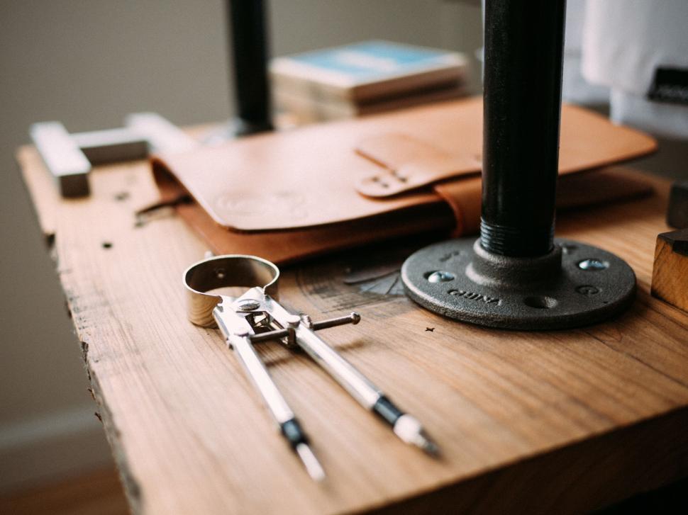 Free Image of Leather crafting tools on wooden workbench 