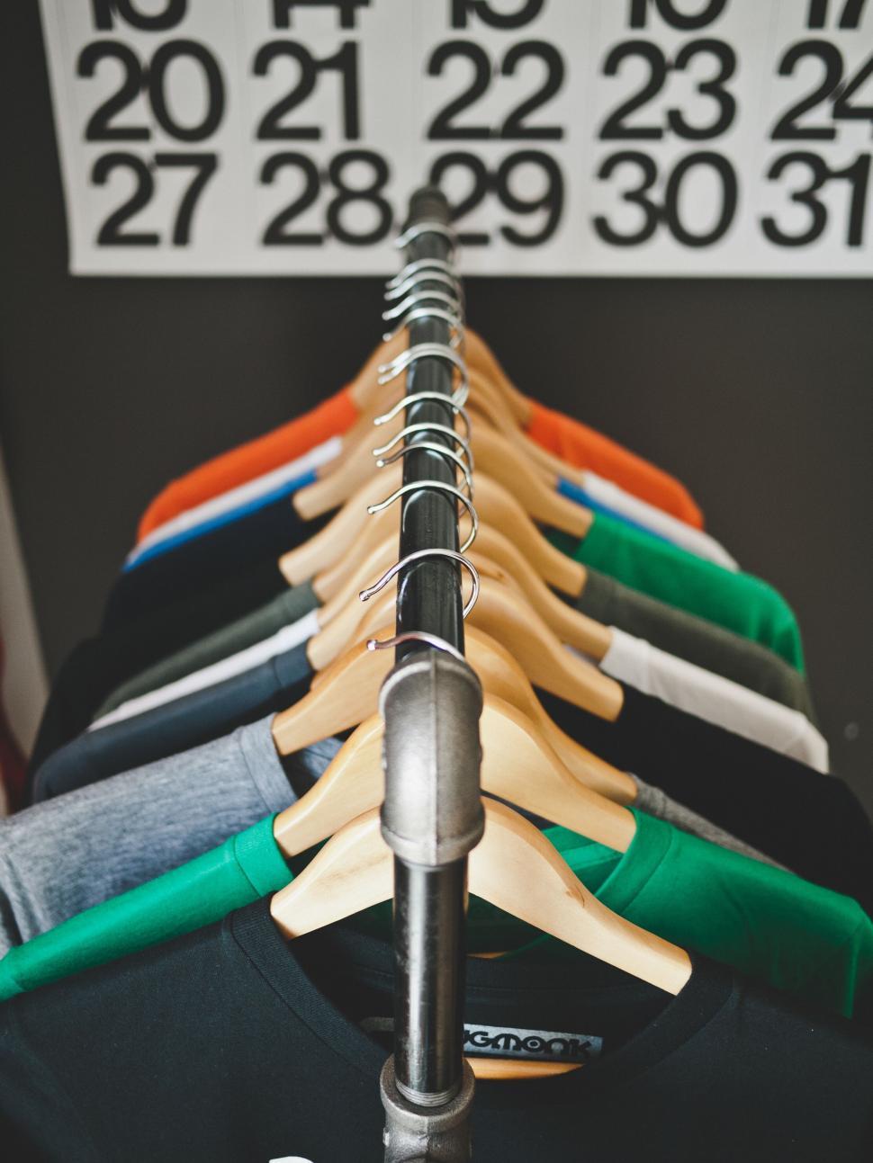 Free Image of Clothes hanging on a metal rack 