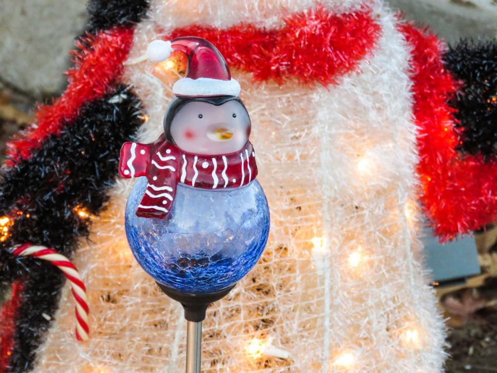 Free Image of Penguin Christmas ornament in festive setting 