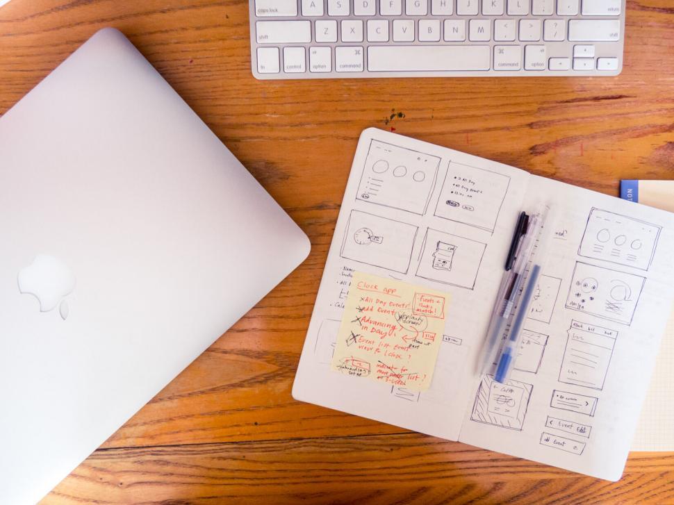 Free Image of Workspace with open laptop and notepad 